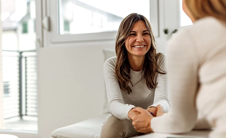 A smiling patient talking with a provider during a follow-up visit